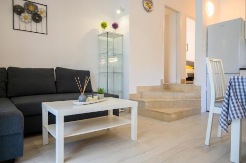 a living room with a couch and a table at Holiday Home Laumar in Klek