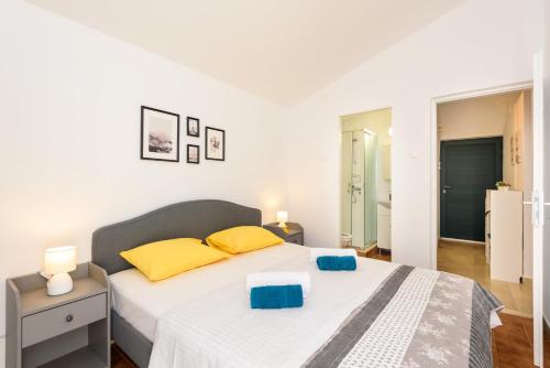 1 dormitorio con 1 cama con almohadas amarillas y azules en Holiday Home Laumar en Klek