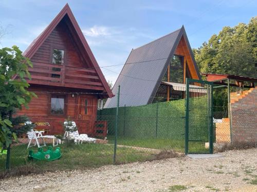 a house with a fence in front of it at Brvnara Beli Kamen 2 in Sremska Mitrovica