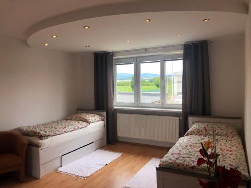 Postel nebo postele na pokoji v ubytování Rodinné apartmány Villa Familia