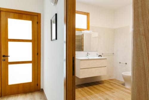a bathroom with a sink and a toilet at Panphilia: Holiday Apartment in Vasto