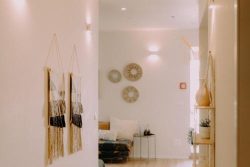 a living room with white walls and a couch at Hippie house בית היפי in Mitzpe Ramon