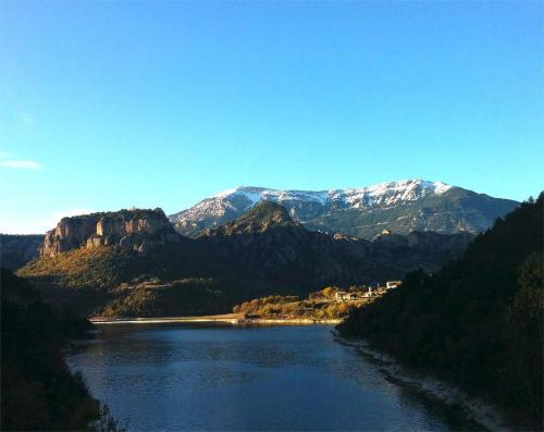 a river with snow capped mountains in the background at Forest Days in Navés