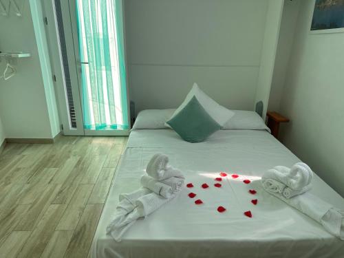 a bed with two towels and hearts on it at Casa del Capitano - Suite Mediterraneo in Ponza