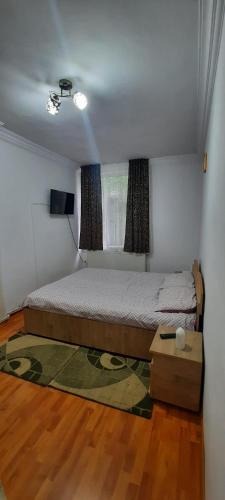 a small bedroom with a bed and a window at Apartament La Denis in Bîrlad