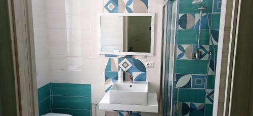 a bathroom with a sink and a mirror at Vico 18 in Gaeta