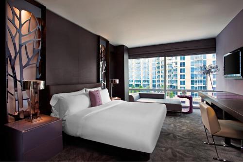 a bedroom with a large white bed and a desk at W Atlanta Downtown in Atlanta