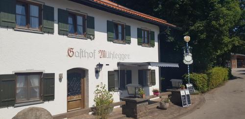 a building with a sign on the side of it at Gasthof Mühlegger in Wildsteig