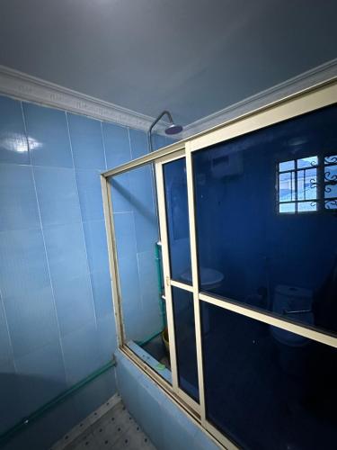 a room with a window and a blue wall at 3 Bedrooms Duplex in Ibadan