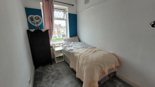 a bedroom with two beds and a window at Mill Lane in Wallasey