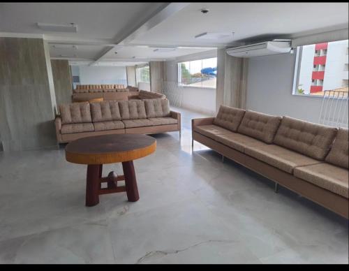 a living room with couches and a table and a stool at SPAZZIO DI ROMA INCLUSO ACQUA PARK SPLASH in Caldas Novas