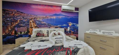 a bedroom with a wall mural of a city at Fashion House Napoli in Naples