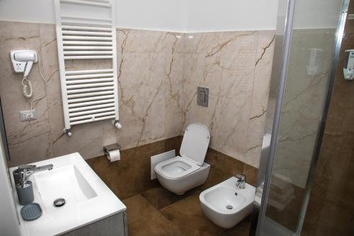 a bathroom with a white toilet and a sink at Villa Giuseppina in Naples