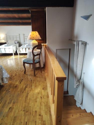 a room with a staircase and a room with two beds at Il Casale Del Cortonese in Sassari