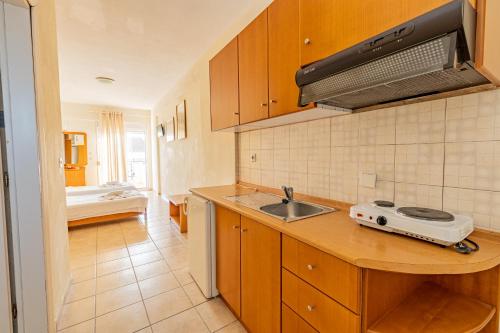 a kitchen with a sink and a counter top at Thalassa Apartments in Kallithea Halkidikis