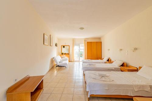 a row of beds in a room at Thalassa Apartments in Kallithea Halkidikis