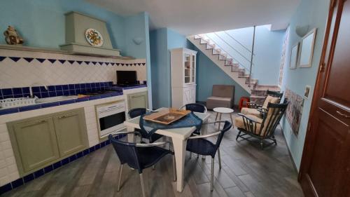 a kitchen with a table and chairs and a staircase at Antica Tonnara in Favignana