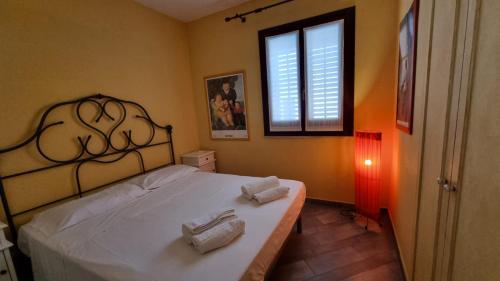 a bedroom with a bed with two towels on it at Antica Tonnara in Favignana