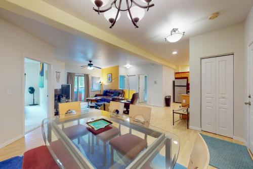 a living room with a glass table in a room at Creekside Retreat C203 in Girdwood
