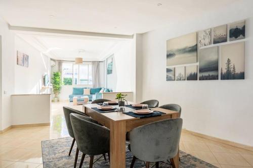 a dining room with a table and chairs at TT Holidays Hassan Tower 3Bedrooms in Rabat