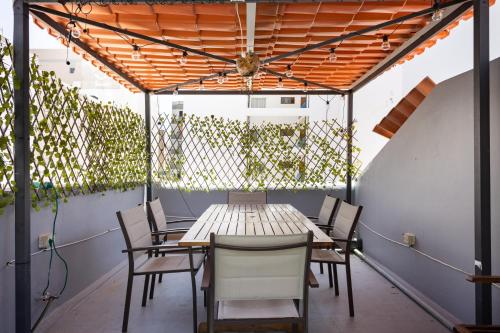 an outdoor dining area with a table and chairs at Wanderlust Hostel in Santa Cruz de Tenerife