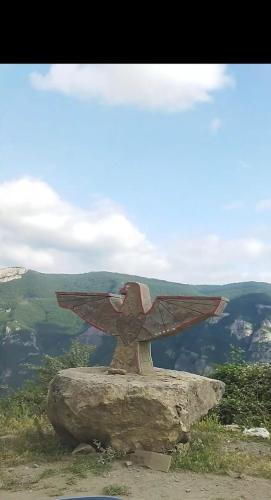 a statue on a rock on top of a mountain at Arman Bed and Breakfast in Halidzor