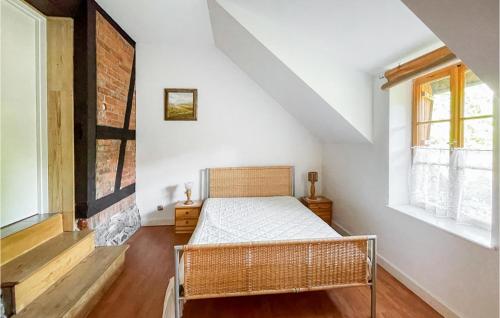 a bedroom with a bed and two windows at Stunning Home In Lidzbark Warminski With 3 Bedrooms in Lidzbark Warmiński