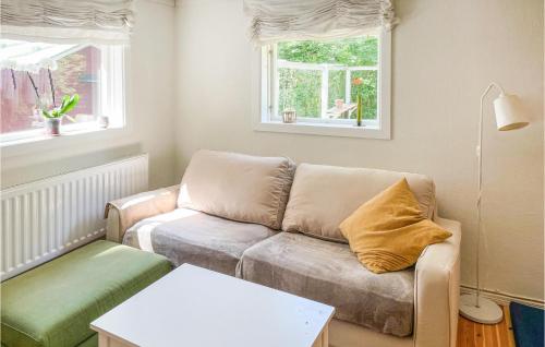 a living room with a couch and a table at Cozy Home In Örebro With Wifi in Örebro