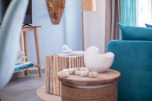 a living room with a blue couch and a table at La Bouverie in Romans-sur-Isère