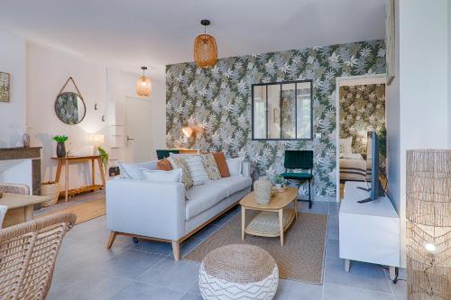 a living room with a couch and a table at La Bouverie in Romans-sur-Isère