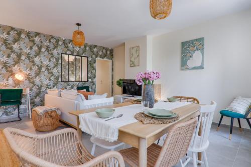 a living room with a table and chairs at La Bouverie in Romans-sur-Isère
