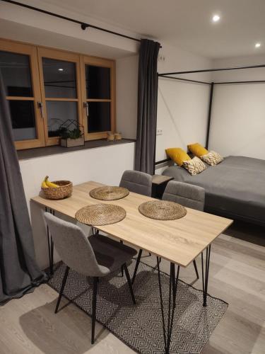 a room with a table and chairs and a bed at Schoberkurve in Raubling