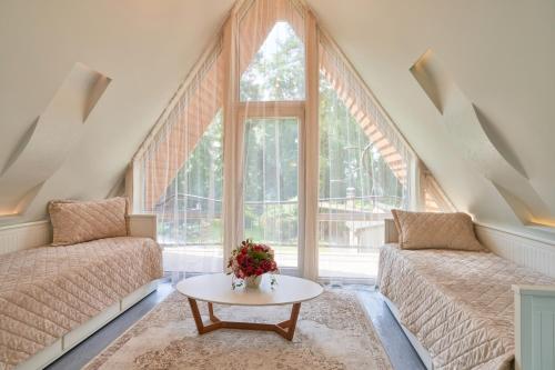 a living room with two beds and a table at Luxury villas Kaunas in Šlienava