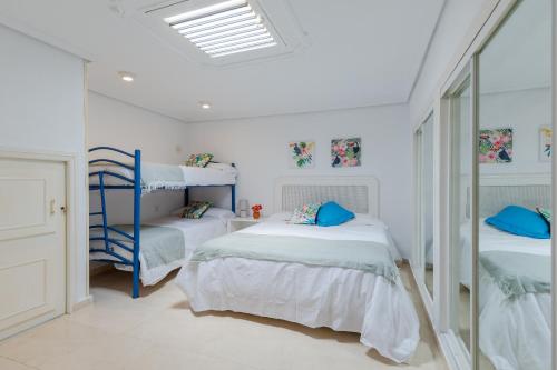 a bedroom with two bunk beds and a skylight at Mediterranean Blue by Fidalsa in Benidorm