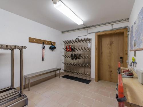 a room with a bench and a bunch of shoes at Karwendel Berglodge in Leutasch