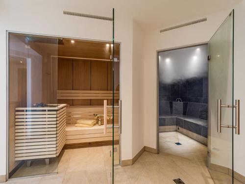 a large bathroom with a shower and a tub at Karwendel Berglodge in Leutasch