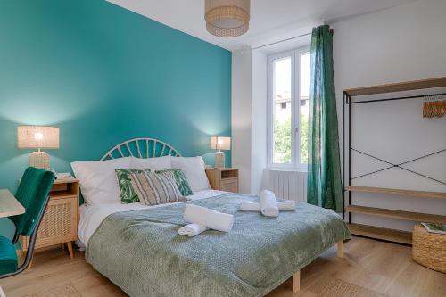 een slaapkamer met een bed met twee handdoeken erop bij La Bouverie in Romans-sur-Isère