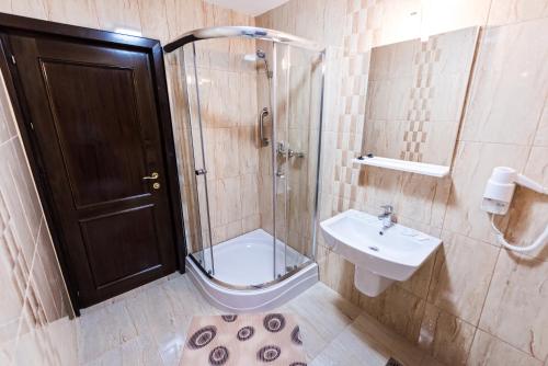 uma casa de banho com um chuveiro, um WC e um lavatório. em Pensiunea Iriss em Valea Lupului