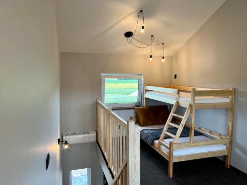 a room with a bunk bed and a ladder at Jaśminowa Park in Zator