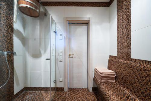 a shower with a glass door in a bathroom at Luxury villas Kaunas in Šlienava