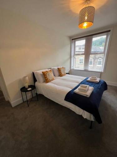 a bedroom with a large bed and a window at Gorgeous home in Hebden Bridge in Hebden Bridge