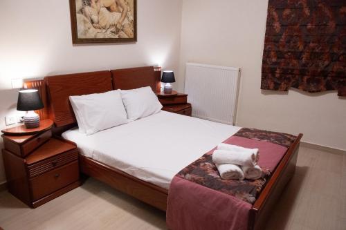 a bedroom with a bed with a teddy bear sitting on a bench at Lovos House in Laganas