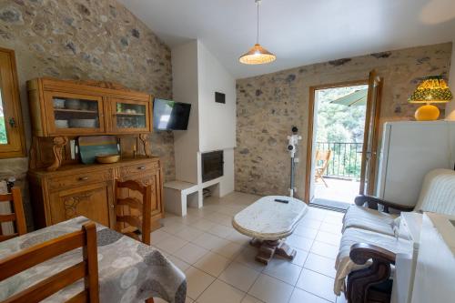 a living room with a couch and a table at La Mazette, les pieds dans l'eau ! Privatisée ! 16 Pers in Olargues