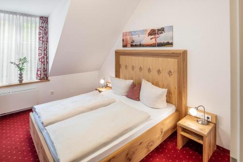 ein Schlafzimmer mit einem großen Holzbett in einem Zimmer in der Unterkunft Langwieder See in München