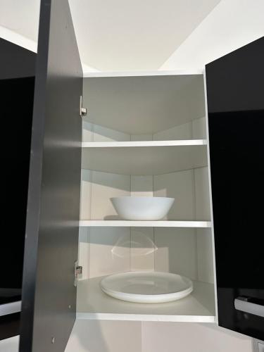 a cabinet with a white plate in it at Byt apartman 2rooms 76m2 all new in Prague