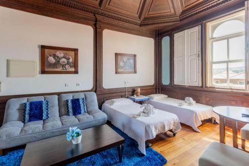 a living room with a couch and two beds at Palacio Nova Seara 2503 - AL in Armamar