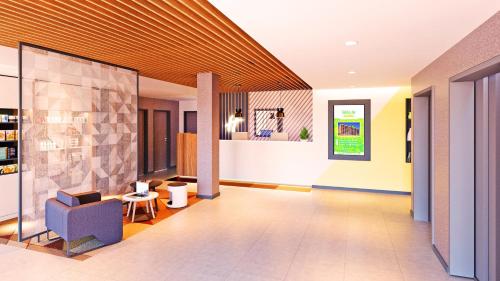 a lobby with a blue chair and a table at Holiday Inn - Eindhoven Airport by IHG in Eindhoven