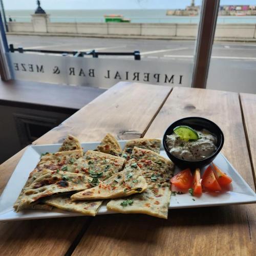 a plate of pita bread with a bowl of soup at Imperial Suites Heart Of Margate! sleeps 6 in Kent