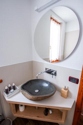 a bathroom with a black sink and a mirror at Nogherazza - La Locanda in Belluno
