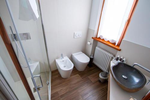 a bathroom with a sink and a toilet at Nogherazza - La Locanda in Belluno